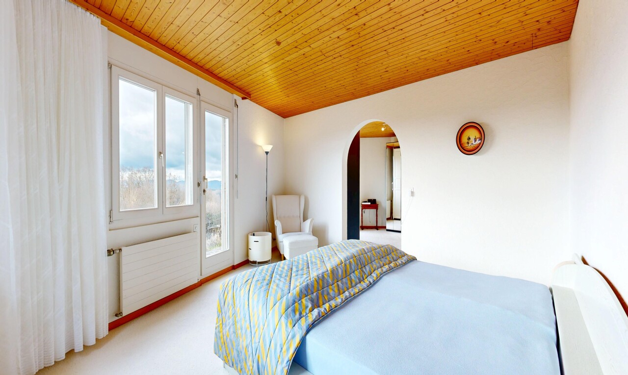 carpeted room featuring arched walkways, radiator heating unit, wooden ceiling, and access to outside