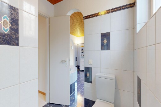 kitchen with tile walls and dark tile patterned floors