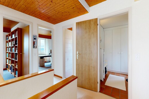 corridor featuring wood ceiling and light tile patterned floors
