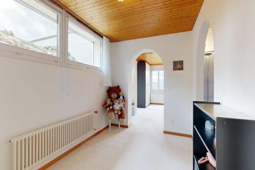 hallway with radiator, wood ceiling, light colored carpet, and arched walkways