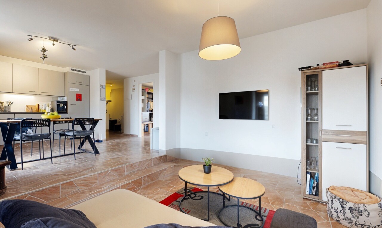 living area with stone tile floors