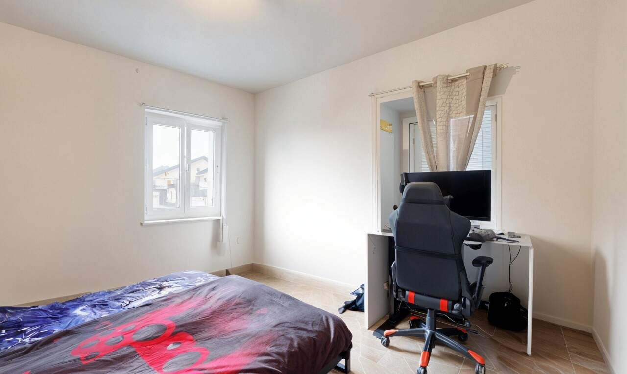 room / bedroom with an office area and baseboards