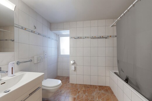 bathroom with tiled shower / bath, tile walls, and vanity