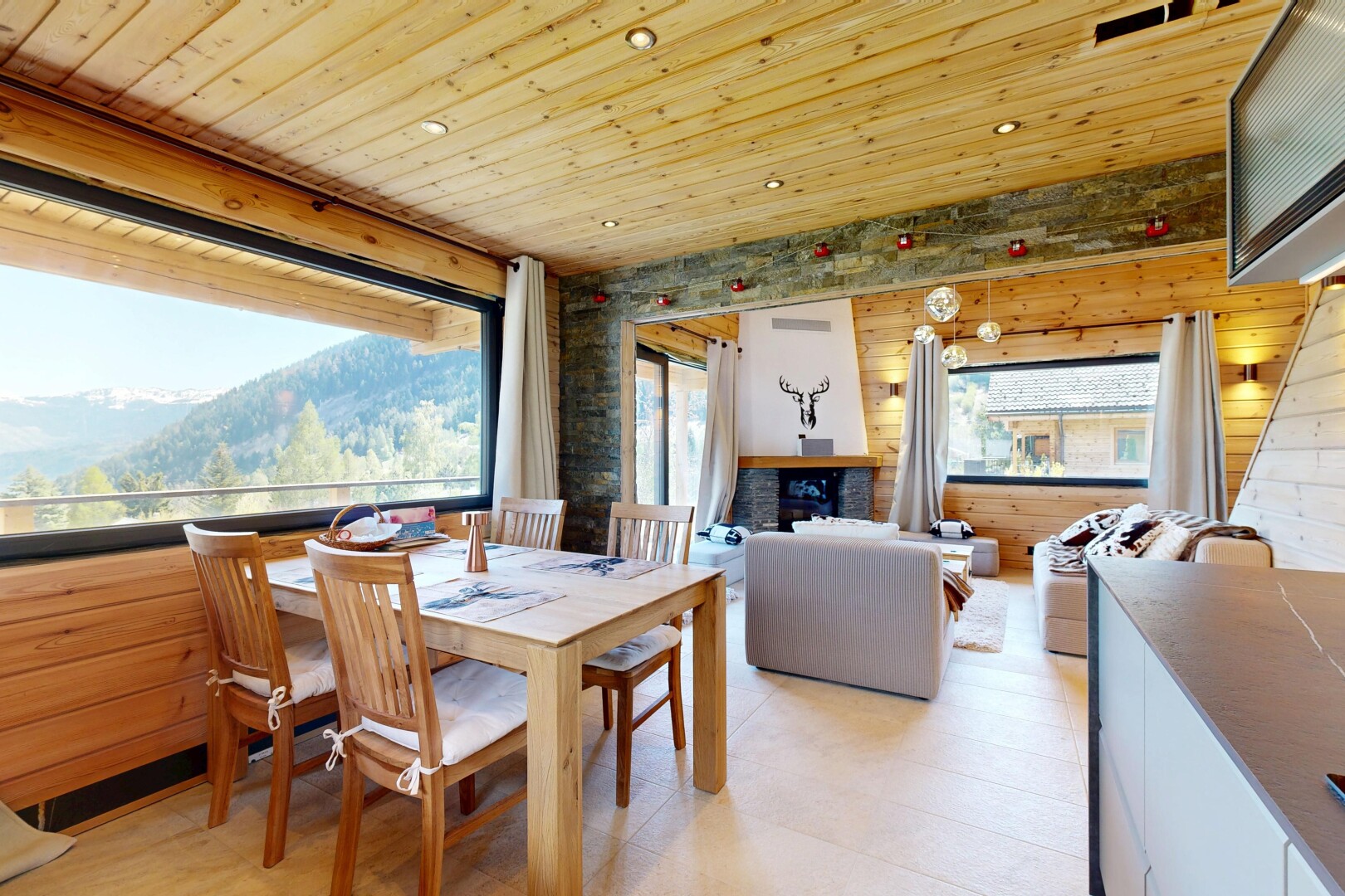 living room featuring a mountain view, recessed lighting, wooden ceiling, and wooden walls