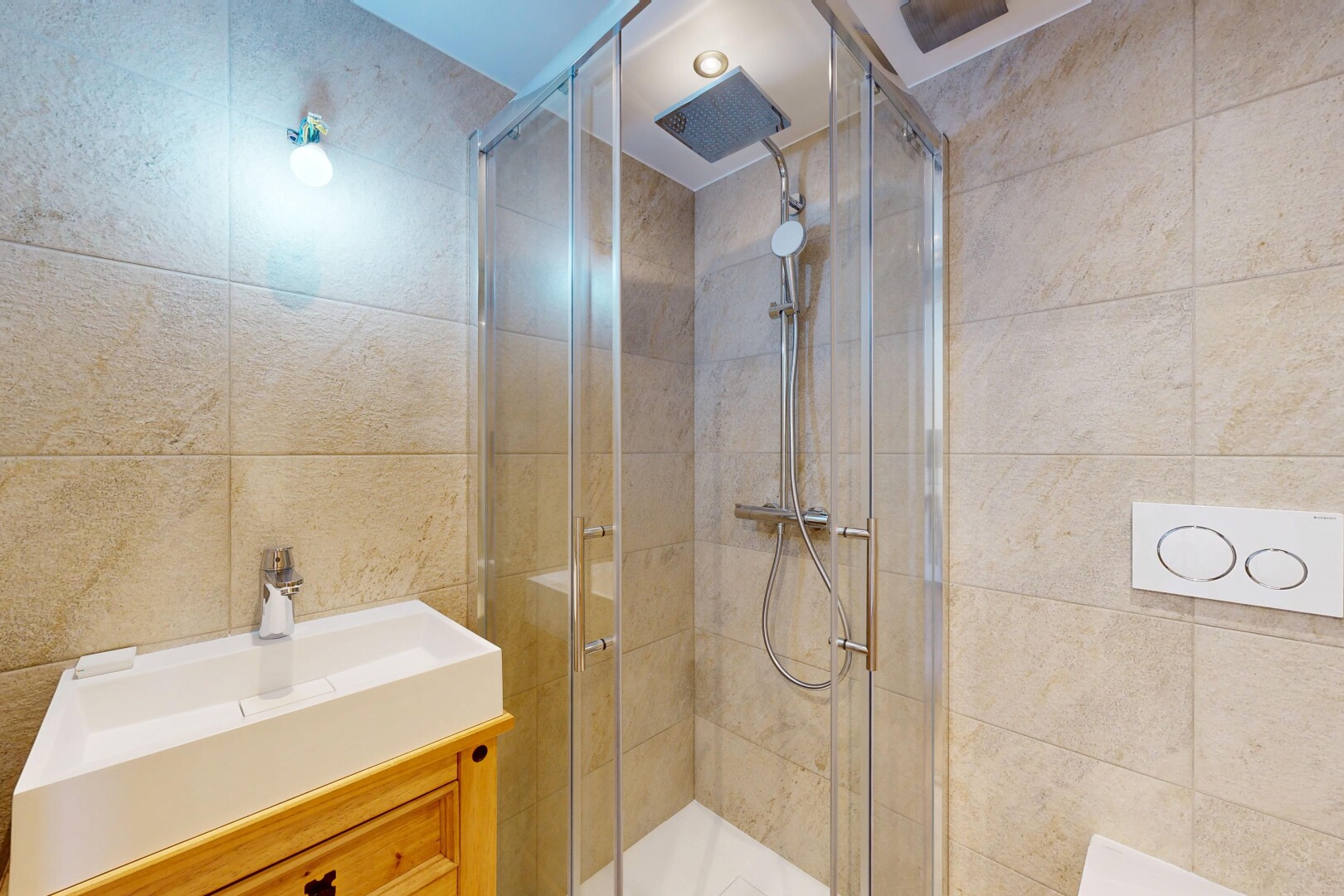bathroom with vanity, tile walls, and a shower stall