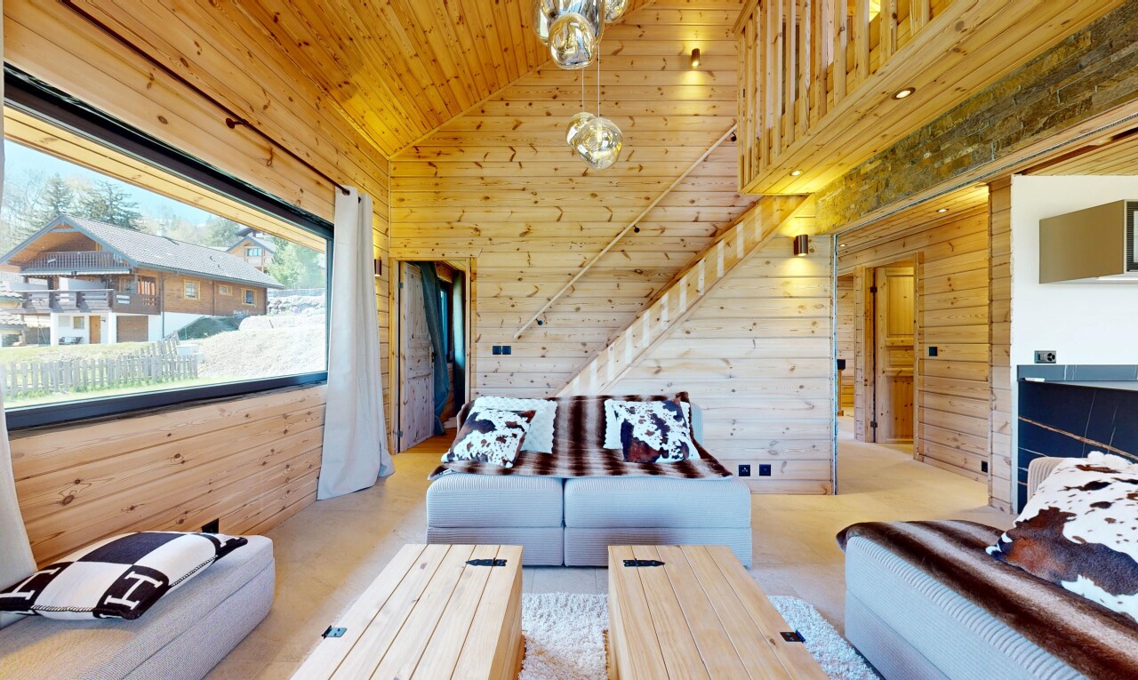 living room with wood walls and a vaulted wood ceiling