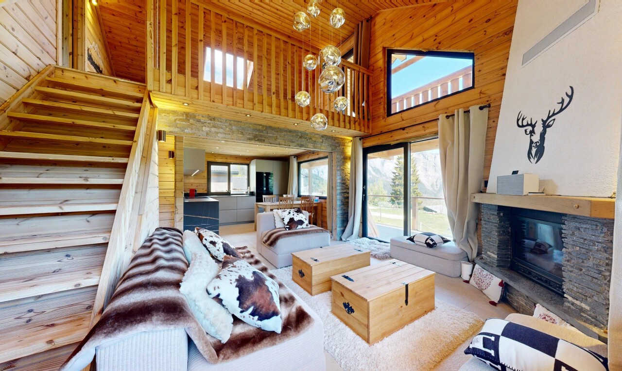 living room featuring wood walls, a fireplace, and a vaulted wooden ceiling