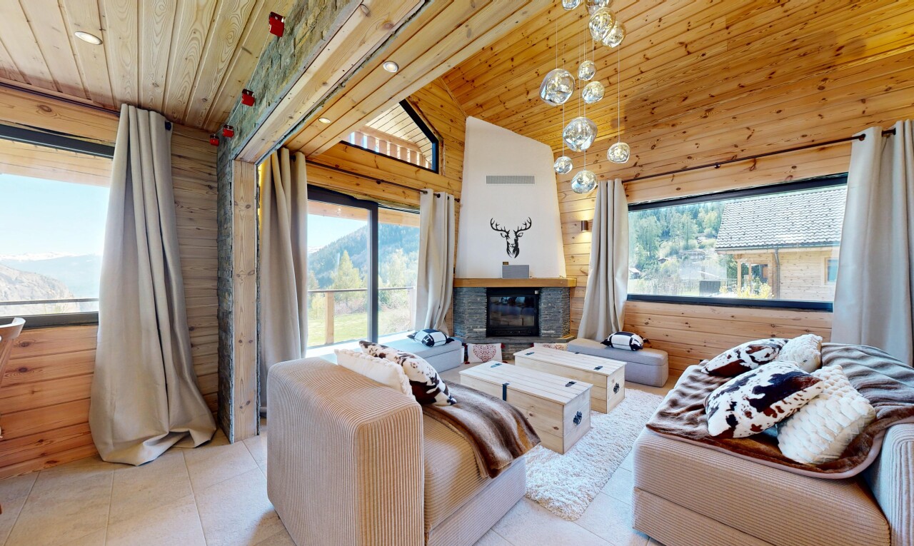 living area with wood walls, a vaulted wood ceiling, and a fireplace