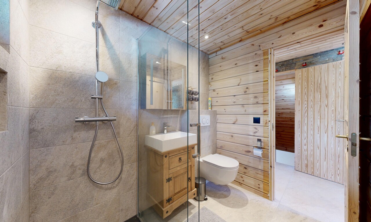 bathroom featuring vanity, wood walls, a tile shower, wood ceiling, and recessed lighting