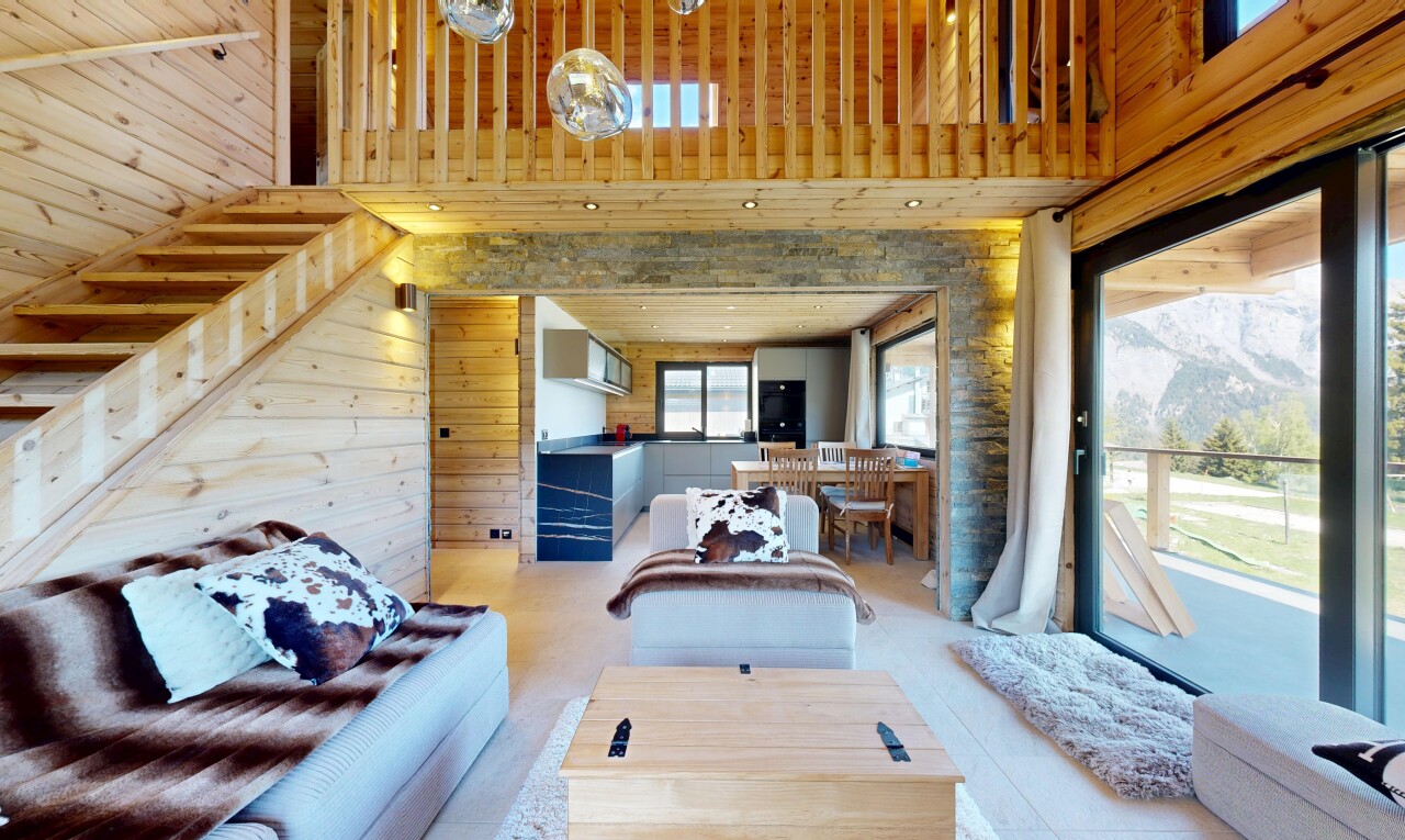 living area featuring a high ceiling and wood walls