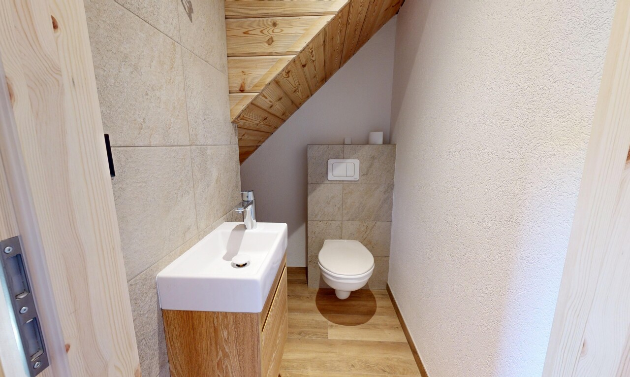 bathroom featuring light wood finished floors, a vaulted wooden ceiling, vanity, and tile walls
