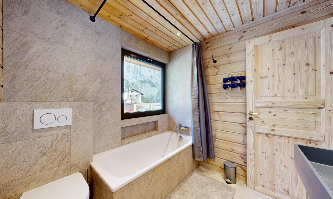 full bathroom featuring a garden tub, wooden ceiling, and wood walls