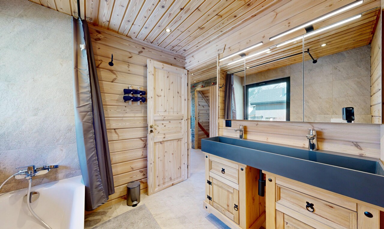 full bath featuring vanity, wooden ceiling, and wood walls