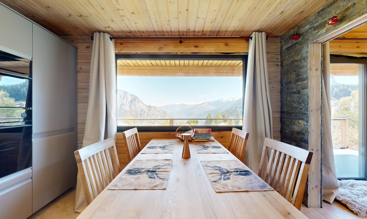 dining area with a mountain view, healthy amount of natural light, and wooden ceiling