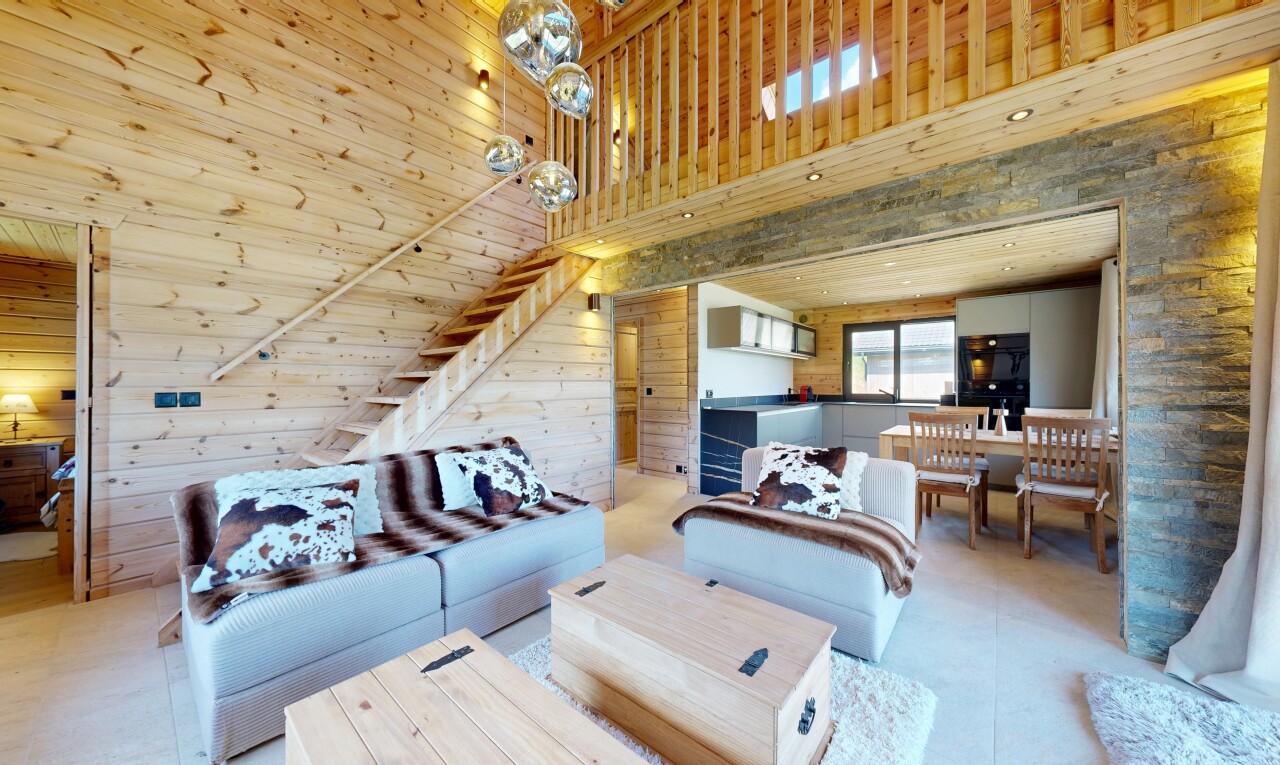 living area with wooden walls and a high ceiling
