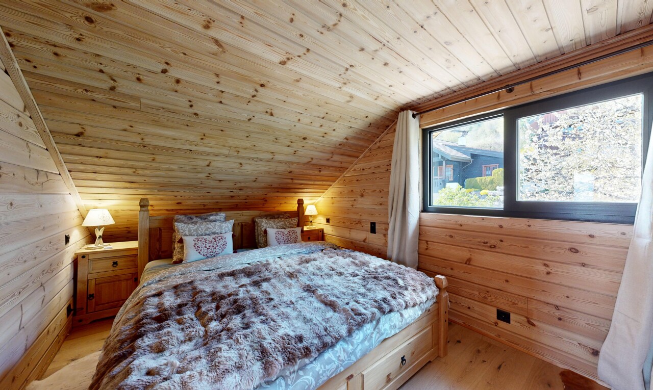 room / bedroom with wooden walls, a vaulted wooden ceiling, and light wood-style floors