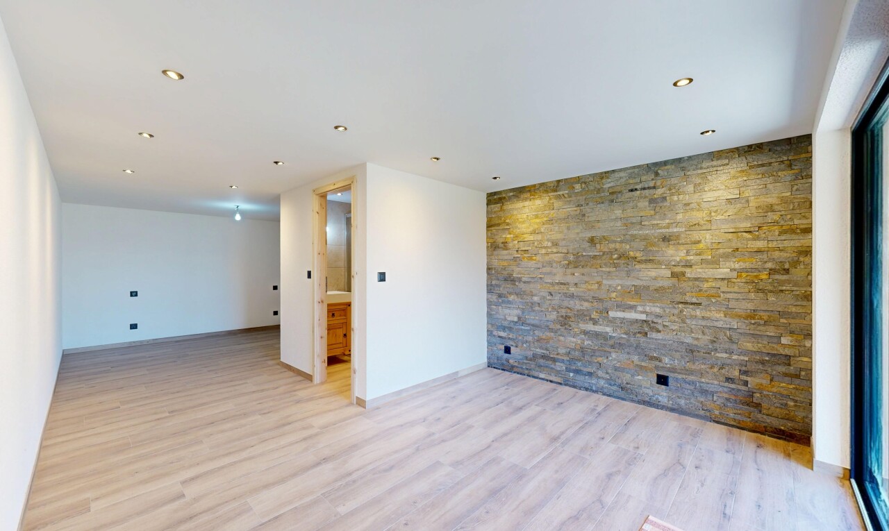 unfurnished room featuring an accent wall and light wood-style flooring
