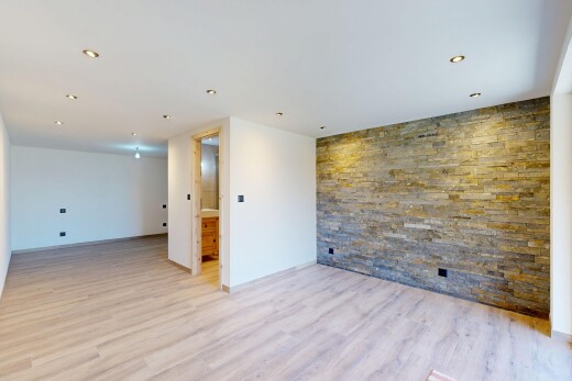 unfurnished room featuring an accent wall and light wood-style flooring