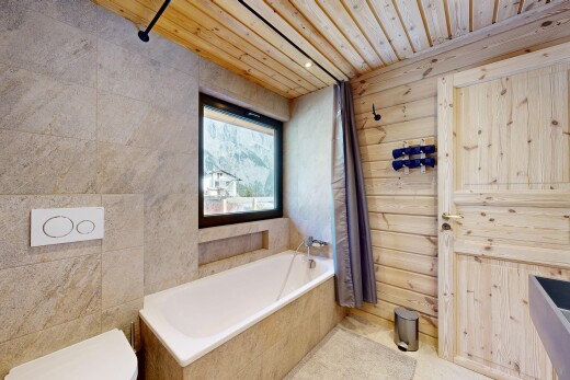 full bathroom featuring a garden tub, wooden ceiling, and wood walls