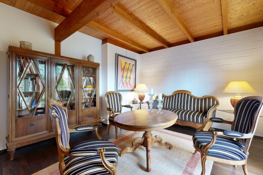 dining room featuring wood finished floors and a wooden ceiling with exposed beams
