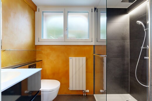 bathroom featuring vanity, a stall shower, and radiator