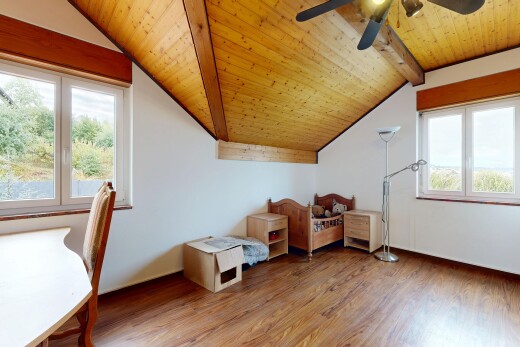 room / bedroom with wood finished floors, a vaulted wooden ceiling, a ceiling fan, and multiple windows