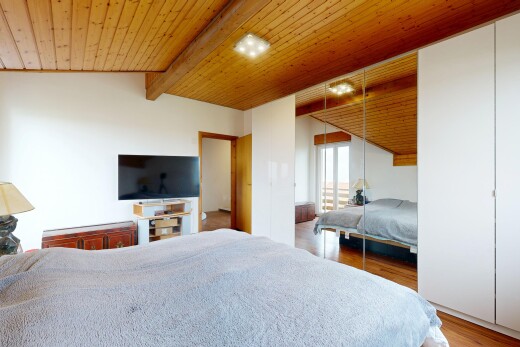 room / bedroom with wooden ceiling, lofted ceiling with beams, a closet, and light wood-style floors