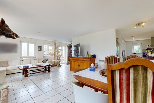 living area with track lighting and light tile patterned floors