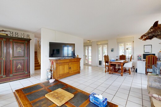 living / dining area featuring stairway and light tile patterned flooring
