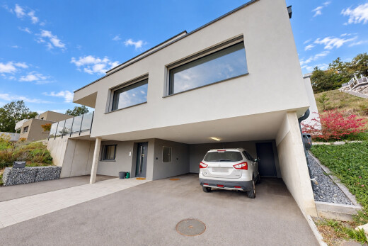 view of property featuring a carport and stucco siding