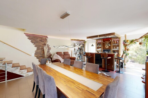 dining space with stairway and a dry bar