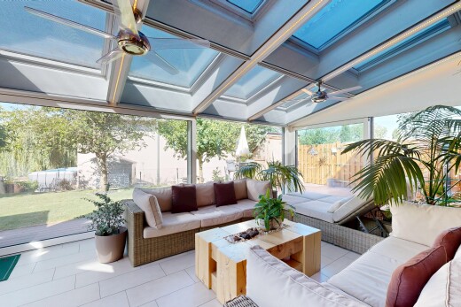 terrace featuring a fenced backyard, ceiling fan, an outdoor living space with a fire pit, and a patio