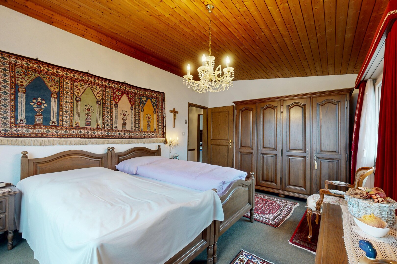 room featuring a chandelier, dark colored carpet, a closet, and wood ceiling