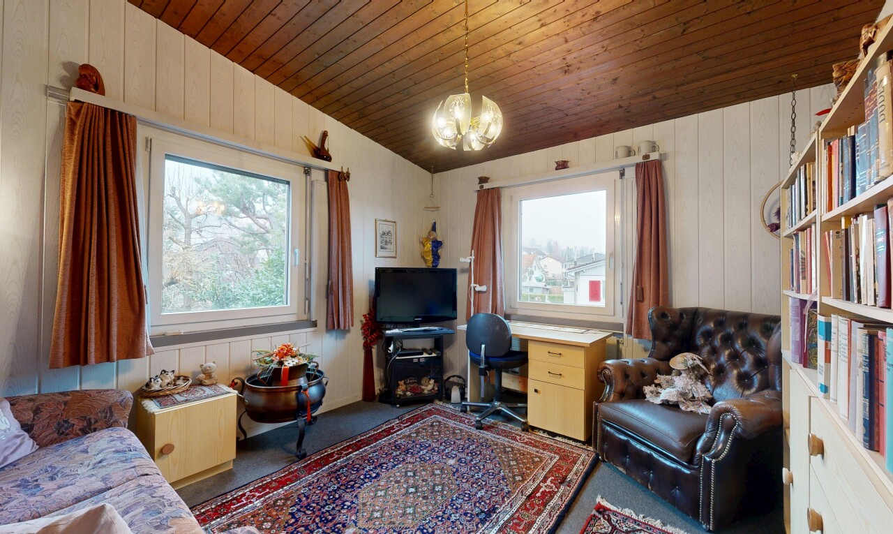 carpeted living area with wood walls, wooden ceiling, healthy amount of natural light, and a chandelier