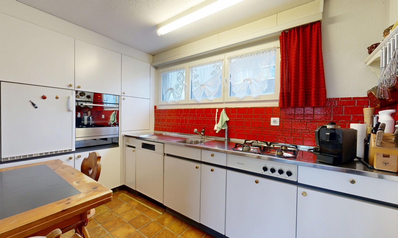 kitchen with stainless steel counters, white cabinets, white appliances, and tasteful backsplash