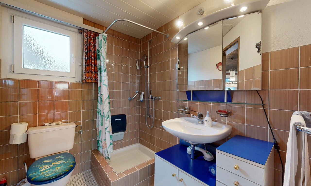 full bath featuring tile walls, a stall shower, and tasteful backsplash