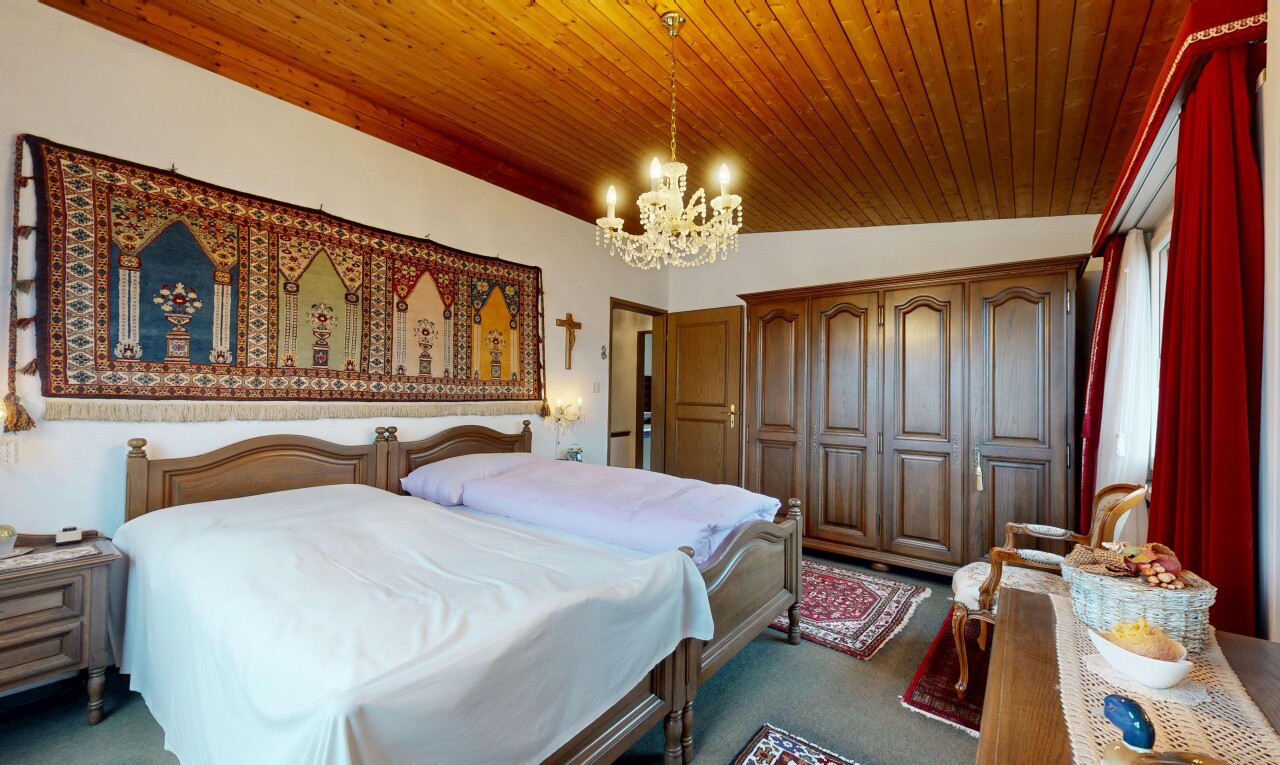 room featuring a chandelier, dark colored carpet, a closet, and wood ceiling