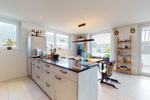 kitchen featuring a peninsula, hanging light fixtures, and light tile patterned floors