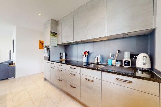 kitchen featuring dark stone countertops, light tile patterned floors, stainless steel oven, backsplash, and recessed lighting