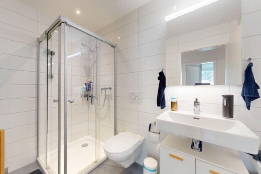 full bathroom featuring tile walls and a stall shower