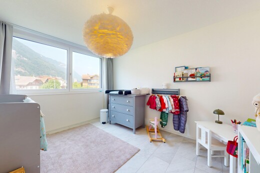 room with a mountain view and light tile patterned floors
