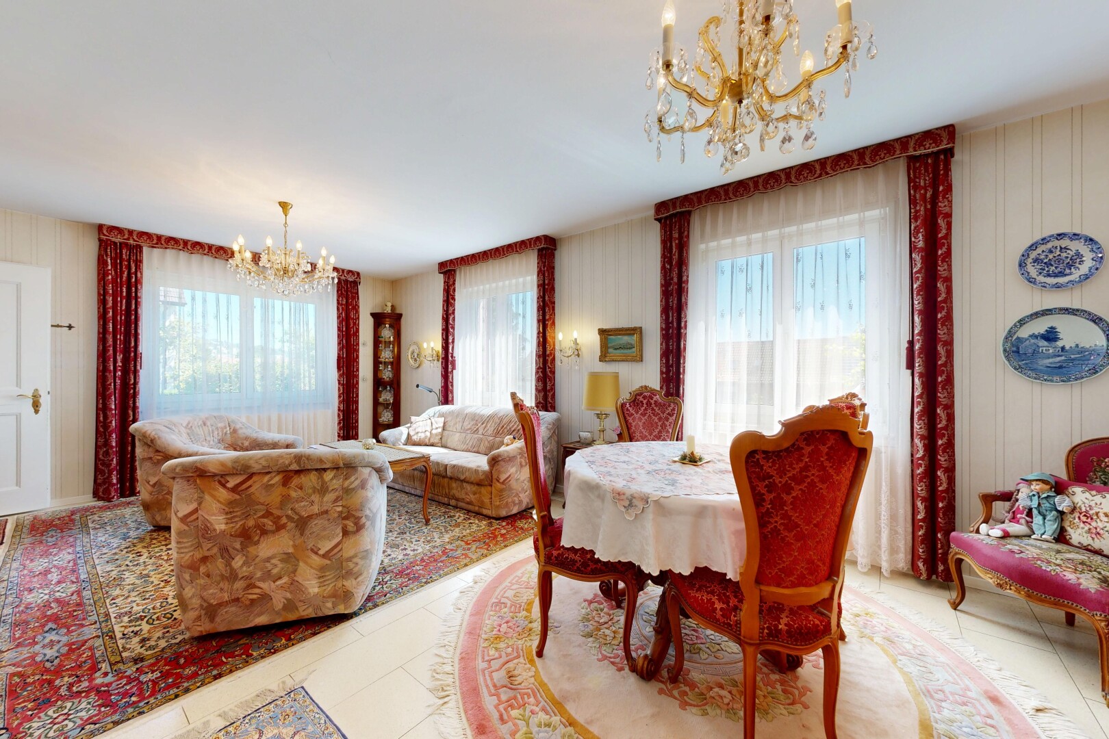 living area featuring a chandelier, light tile patterned floors, and healthy amount of natural light