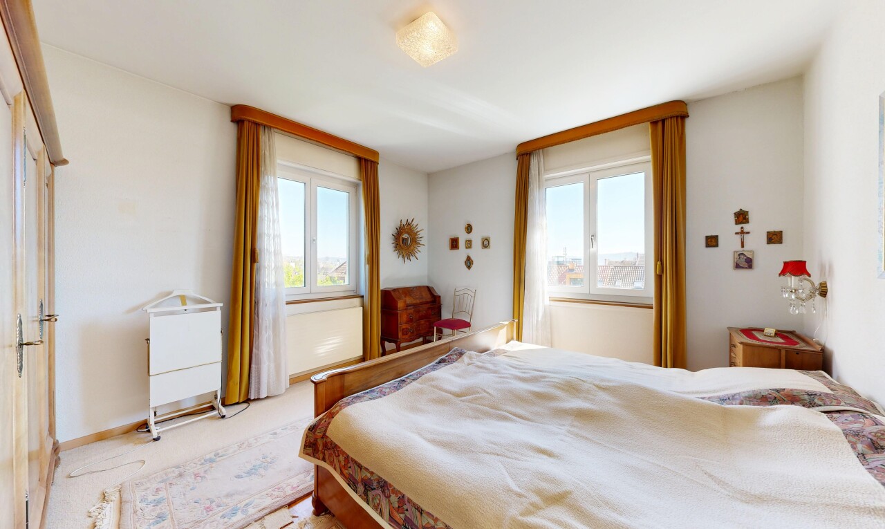 carpeted room with baseboards