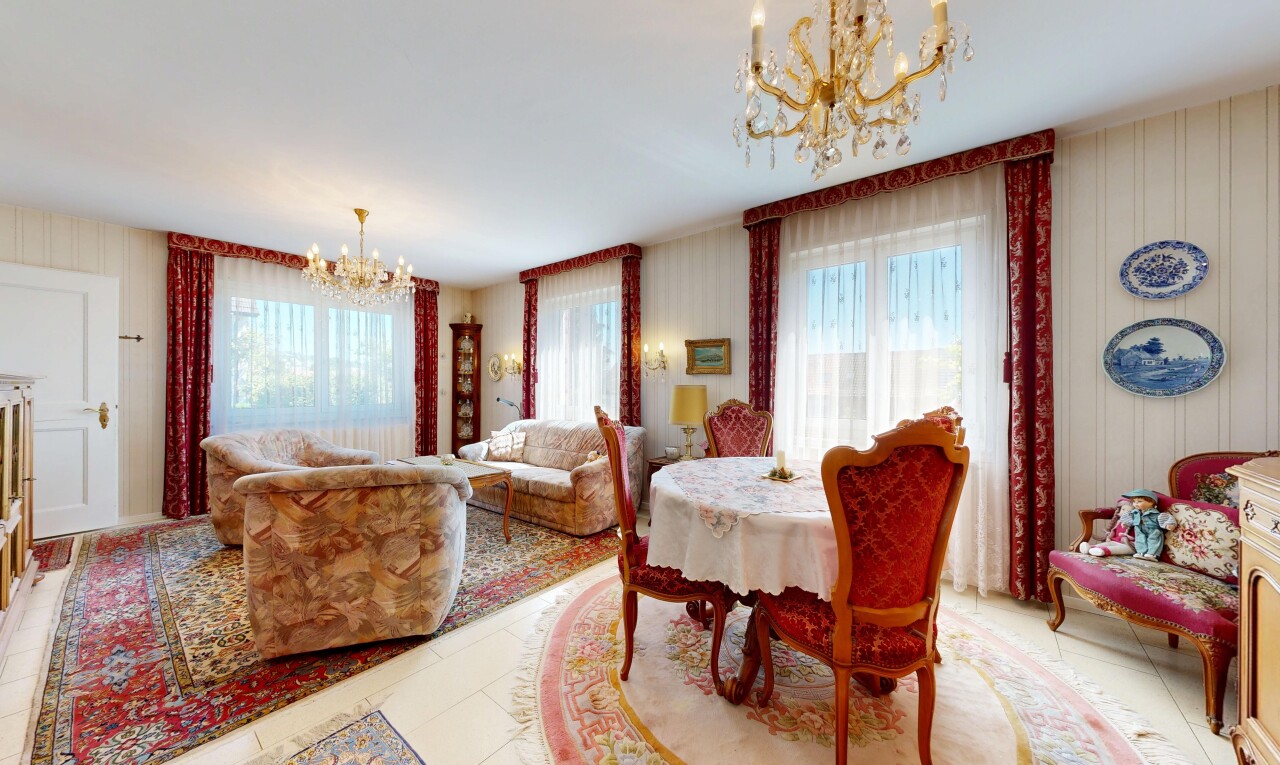 living area featuring a chandelier, light tile patterned floors, and healthy amount of natural light