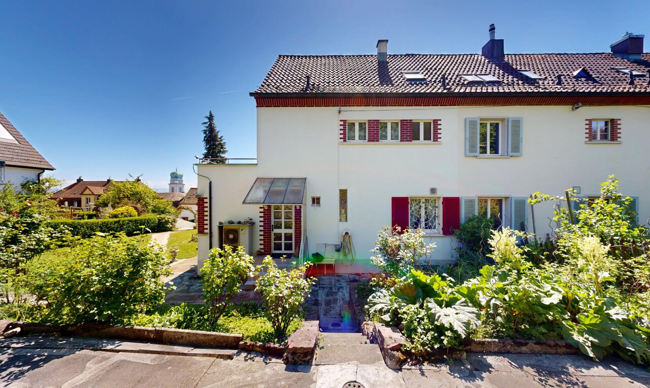 view of property with a chimney, stucco siding, and a tile roof