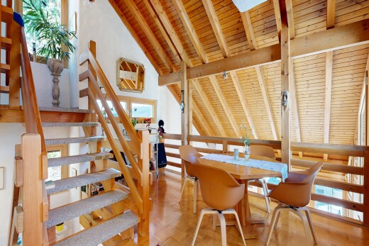 staircase with a high wooden beamed ceiling and parquet flooring