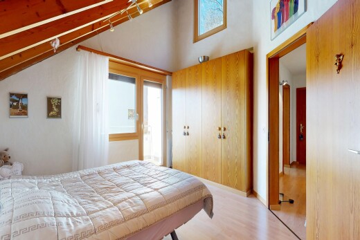room / bedroom with light wood-type flooring and a high ceiling