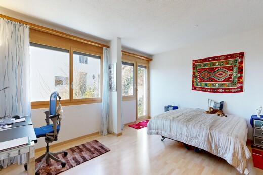 room / bedroom with a desk, light wood-style flooring, and access to exterior