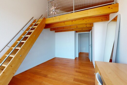 unfurnished room with light wood-type flooring and a high ceiling