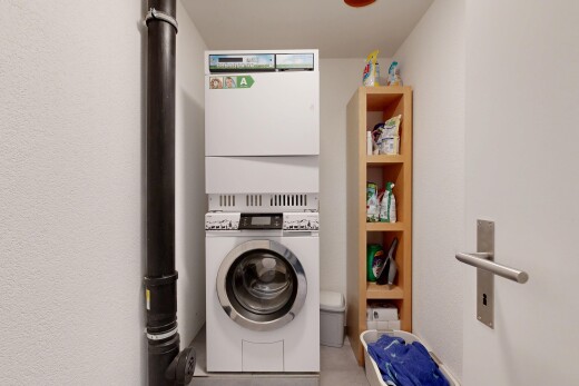 laundry room with stacked washing machine and dryer
